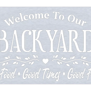 A rectangular aluminum wall sign with the words 'Welcome To Our Backyard' at the top. Below, 'Good Food, Good Times, Good Friends' is arranged with a decorative heart in the center. The sign has a brushed metal finish, suitable for outdoor use.